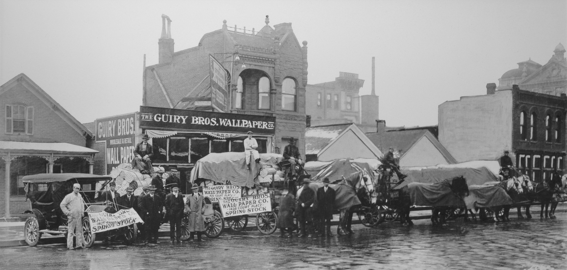 Archival black and white photograph of the original Guiry's store on Court Place, featuring the vintage storefront with 'Guiry's' signage and classic early 20th-century architecture.