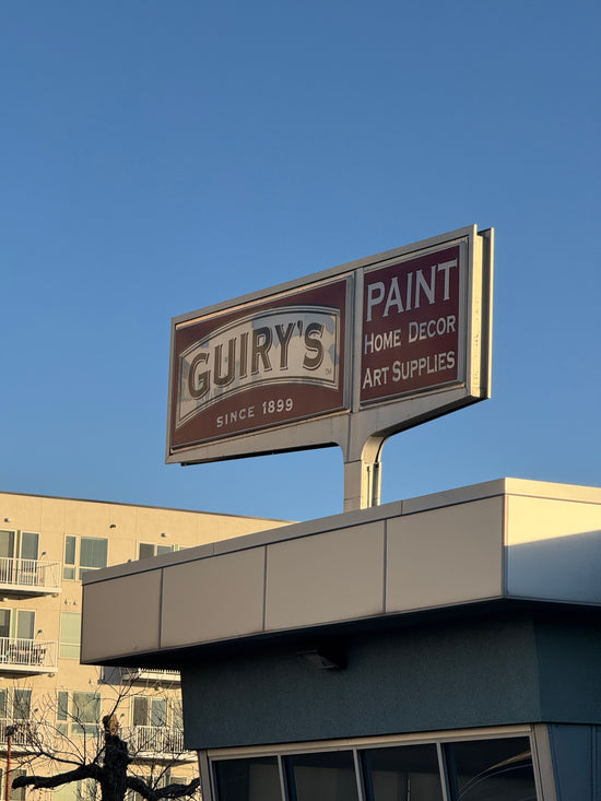 Gulley's paint store sign on a building against a clear blue sky