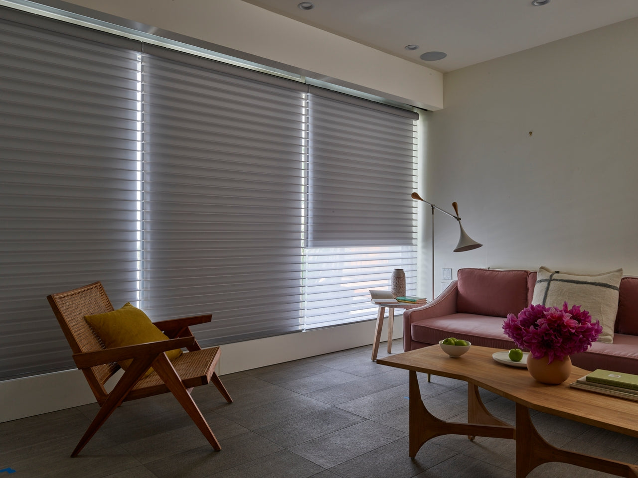 Modern living room with a sofa, armchair, and coffee table and Silhouette Window Shadings